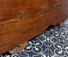 Load image into Gallery viewer, A beautiful Anglo-Indian Marriage Dowry chest circa 1900 with campaign handles and original wooden wheels, a very well-crafted and decorative chest, decorated with brass inlaid wire work, classically indicative of Indian artistry. This piece is a fine example of an Anglo-Indian chest. Designed as a dowry piece to be given by the father of the bride in an Indian wedding, you would have gold, jewellery, land deeds, money and fine linens stored inside.
