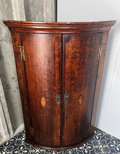 Load image into Gallery viewer, All original brass hinges and escutcheons, fancy rococo brass escutcheons and brass H-hinges and beautifully figured oak doors with mahogany banding to the edges and beautiful shell inlay design with multiple tones of veneer above a shaped pelmet.
