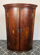 Load image into Gallery viewer, All original brass hinges and escutcheons, fancy rococo brass escutcheons and brass H-hinges and beautifully figured oak doors with mahogany banding to the edges and beautiful shell inlay design with multiple tones of veneer above a shaped pelmet.
