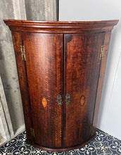 Load image into Gallery viewer, All original brass hinges and escutcheons, fancy rococo brass escutcheons and brass H-hinges and beautifully figured oak doors with mahogany banding to the edges and beautiful shell inlay design with multiple tones of veneer above a shaped pelmet.
