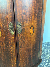 Load image into Gallery viewer, All original brass hinges and escutcheons, fancy rococo brass escutcheons and brass H-hinges and beautifully figured oak doors with mahogany banding to the edges and beautiful shell inlay design with multiple tones of veneer above a shaped pelmet.
