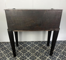 Load image into Gallery viewer, Constructed from rich dark oak, it features a plain, authentic craftsmanship design supported by chunky tapered legs. The hinged lid features excellent dark iron pads with a striking bolt finish. The interior includes a drawer panel that opens to reveal two hidden drawers that slide across, adding a touch of period charm
