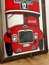 Load image into Gallery viewer, The mirror prominently features a red London double-decker bus with TRAFALGAR SQUARE and 12 on its destination sign, and Coca-Cola branding on the side of the bus. The license plate reads LON 80.
