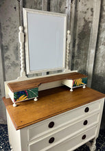 Load image into Gallery viewer, Beautiful vintage shabby chic dressing table with a stylish mirror and sleek drawers. This piece features a painted finish country cream with a contrasting natural wooden top, its distinctive floral patterned drawer fronts add a unique touch.
