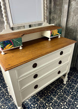 Load image into Gallery viewer, Beautiful vintage shabby chic dressing table with a stylish mirror and sleek drawers. This piece features a painted finish country cream with a contrasting natural wooden top, its distinctive floral patterned drawer fronts add a unique touch.
