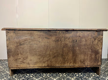 Load image into Gallery viewer, The antique oak coffer is of simple, plain form and has a hinged lid that opens to reveal a spacious interior. The coffer has a three-panel front and is raised on block feet. One of my favourite parts is the back panel that has been crudely chiselled from one section of oak, with an excellent, authentic craftsmanship finish.
