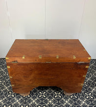 Load image into Gallery viewer, A beautiful Anglo-Indian Marriage Dowry chest circa 1900 with campaign handles and original wooden wheels, a very well-crafted and decorative chest, decorated with brass inlaid wire work, classically indicative of Indian artistry. This piece is a fine example of an Anglo-Indian chest. Designed as a dowry piece to be given by the father of the bride in an Indian wedding, you would have gold, jewellery, land deeds, money and fine linens stored inside.
