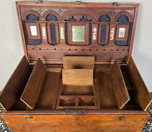 Load image into Gallery viewer, A beautiful Anglo-Indian Marriage Dowry chest circa 1900 with campaign handles and original wooden wheels, a very well-crafted and decorative chest, decorated with brass inlaid wire work, classically indicative of Indian artistry. This piece is a fine example of an Anglo-Indian chest. Designed as a dowry piece to be given by the father of the bride in an Indian wedding, you would have gold, jewellery, land deeds, money and fine linens stored inside.
