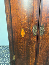Load image into Gallery viewer, All original brass hinges and escutcheons, fancy rococo brass escutcheons and brass H-hinges and beautifully figured oak doors with mahogany banding to the edges and beautiful shell inlay design with multiple tones of veneer above a shaped pelmet.
