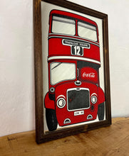 Load image into Gallery viewer, The mirror prominently features a red London double-decker bus with TRAFALGAR SQUARE and 12 on its destination sign, and Coca-Cola branding on the side of the bus. The license plate reads LON 80.
