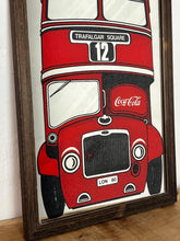 Load image into Gallery viewer, The mirror prominently features a red London double-decker bus with TRAFALGAR SQUARE and 12 on its destination sign, and Coca-Cola branding on the side of the bus. The license plate reads LON 80.
