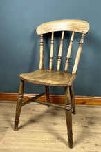 Load image into Gallery viewer, This style is a type of Windsor chair, a design that originated in England in the early 18th century and is characterised by its solid wooden seat into which the legs and spindles of the back are inserted.
