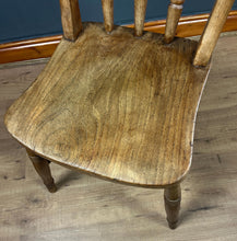 Load image into Gallery viewer, This style is a type of Windsor chair, a design that originated in England in the early 18th century and is characterised by its solid wooden seat into which the legs and spindles of the back are inserted.
