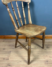 Load image into Gallery viewer, This style is a type of Windsor chair, a design that originated in England in the early 18th century and is characterised by its solid wooden seat into which the legs and spindles of the back are inserted.
