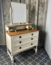 Load image into Gallery viewer, Beautiful vintage shabby chic dressing table with a stylish mirror and sleek drawers. This piece features a painted finish country cream with a contrasting natural wooden top, its distinctive floral patterned drawer fronts add a unique touch.

