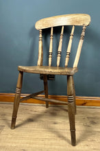 Load image into Gallery viewer, This style is a type of Windsor chair, a design that originated in England in the early 18th century and is characterised by its solid wooden seat into which the legs and spindles of the back are inserted.
