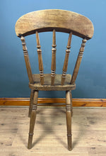 Load image into Gallery viewer, This style is a type of Windsor chair, a design that originated in England in the early 18th century and is characterised by its solid wooden seat into which the legs and spindles of the back are inserted.

