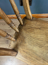 Load image into Gallery viewer, This style is a type of Windsor chair, a design that originated in England in the early 18th century and is characterised by its solid wooden seat into which the legs and spindles of the back are inserted.

