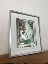 Load image into Gallery viewer, The woman’s hair, wild and swirling through a play of ornate interweaving lines, is a typical Mucha style feature. When this was created, women generally did not smoke in public and usually wore their hair up, making this a daring and wild piece. The geometric shape repeated in the background is the company’s logo.
