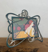 Load image into Gallery viewer, Beautiful vintage picture frame designed in the Art Deco style, featuring ornate, flowing lines and a green enamel finish. It is made from metal, likely pewter or a silver-plated alloy.
