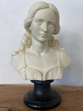 Load image into Gallery viewer, The figure depicts a young woman with wavy hair gathered into ringlets over her shoulders, wearing a draped garment with spaghetti straps and rosette detailing. Her facial expression is serene with downcast eyes.
