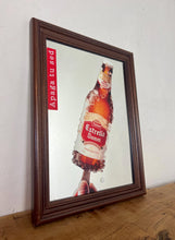 Load image into Gallery viewer, The main image is a unique graphic of an ice-encrusted Estrella Damm bottle held like a popsicle or ice lolly by a hand.
