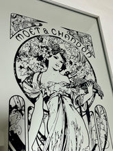 Load image into Gallery viewer, Gorgeous, vibrant Art Nouveau mirror featuring stunning, intricate designs of a beautiful lady against a floral background, with a stand-on designer branding with the famous champagne maker.
