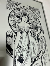 Load image into Gallery viewer, Gorgeous, vibrant Art Nouveau mirror featuring stunning, intricate designs of a beautiful lady against a floral background, with a stand-on designer branding with the famous champagne maker.
