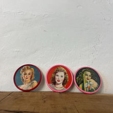 Load image into Gallery viewer, Beautiful mid-century vintage compact mirrors or small circular handbag mirrors featuring pin-up style art from the mid-20th century.
