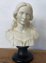 Load image into Gallery viewer, The figure depicts a young woman with wavy hair gathered into ringlets over her shoulders, wearing a draped garment with spaghetti straps and rosette detailing. Her facial expression is serene with downcast eyes.
