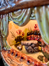 Load image into Gallery viewer, This style of hand-painted, glazed ceramic item, sometimes featuring floral designs or specific scenes, has a whimsical, hand-painted design with a military theme, incorporating several small seated toy figures and a cannon figurine.
