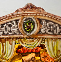 Load image into Gallery viewer, This style of hand-painted, glazed ceramic item, sometimes featuring floral designs or specific scenes, has a whimsical, hand-painted design with a military theme, incorporating several small seated toy figures and a cannon figurine.
