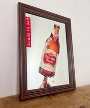 Load image into Gallery viewer, The main image is a unique graphic of an ice-encrusted Estrella Damm bottle held like a popsicle or ice lolly by a hand.
