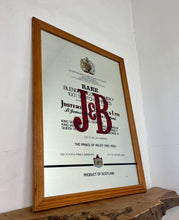 Load image into Gallery viewer, The most prominent feature is the large, bold, red "J&amp;B" logo in a distinctive typeface.
