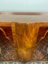Load image into Gallery viewer, This beautiful piece is a 1930s English Art Deco cocktail cabinet, characterized by its figured walnut veneers and distinctive geometric glazed doors.
