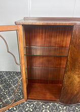 Load image into Gallery viewer, This beautiful piece is a 1930s English Art Deco cocktail cabinet, characterized by its figured walnut veneers and distinctive geometric glazed doors.
