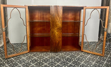 Load image into Gallery viewer, This beautiful piece is a 1930s English Art Deco cocktail cabinet, characterized by its figured walnut veneers and distinctive geometric glazed doors.
