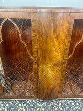 Load image into Gallery viewer, This beautiful piece is a 1930s English Art Deco cocktail cabinet, characterized by its figured walnut veneers and distinctive geometric glazed doors.
