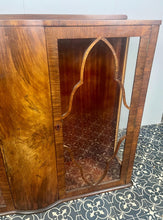 Load image into Gallery viewer, This beautiful piece is a 1930s English Art Deco cocktail cabinet, characterized by its figured walnut veneers and distinctive geometric glazed doors.
