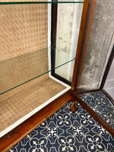 Load image into Gallery viewer, This stunning piece is an antique Art Deco display cabinet, dating from the 1930s. It is characterised by its walnut or mahogany construction, featuring astragal-glazed doors with a distinctive curved pattern and claw-and-ball feet.
