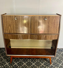 Load image into Gallery viewer, This stylish piece of furniture is a vintage mid-century modern (MCM) bureau and drinks cabinet, often attributed to the maker Hubbinet.

