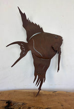 Load image into Gallery viewer, Add a touch of coastal soul and mid-century character to your home with this stunning vintage metal angelfish wall sculpture. Equal parts rustic folk art and bold Brutalist design, this hand-crafted piece features an incredibly expressive silhouette, complete with flowing fins and layered, wavy cut-outs that capture the graceful motion of life underwater.The sculpture has a rich, deep brown finish with a natural, time-worn patina that gives it undeniable antique warmth.
