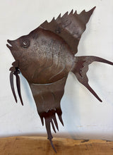 Load image into Gallery viewer, Add a touch of coastal soul and mid-century character to your home with this stunning vintage metal angelfish wall sculpture. Equal parts rustic folk art and bold Brutalist design, this hand-crafted piece features an incredibly expressive silhouette, complete with flowing fins and layered, wavy cut-outs that capture the graceful motion of life underwater.The sculpture has a rich, deep brown finish with a natural, time-worn patina that gives it undeniable antique warmth.
