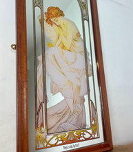 Load image into Gallery viewer, Beautiful vintage Mucha art nouveau design showing a glamorous lady wearing an elegant pastel peach flowing dress—superb detail posing, resting on a shoal draped over a chair. The stained glass border, intricate pattern design, and vivid matt colour.
