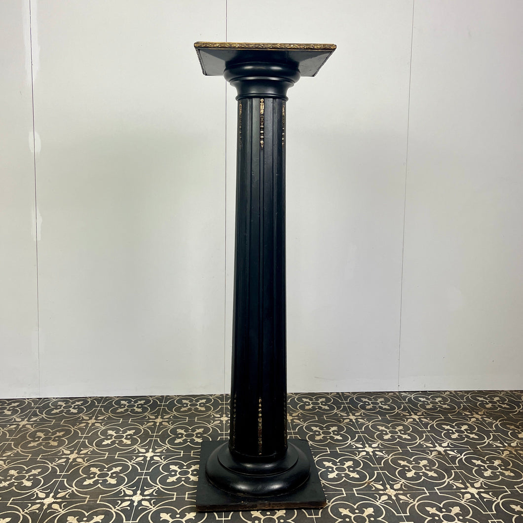 The piece has a beautiful chunky fluted column with a desirable and fashionable ebony tone set with ormolu mounts in a droplet design with floral embellishment in differing lengths on the column a stunning design set on a square base with hidden feet