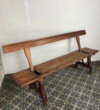 Load image into Gallery viewer, A beautiful Victorian period, pitch pine long, wide and comfortable railway bench, dating from the 2nd half of the 19th century with stunning patina. The bench features an ingenious swing-back design, so it can be sat on from both sides.
