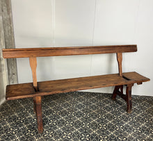 Load image into Gallery viewer, A beautiful Victorian period, pitch pine long, wide and comfortable railway bench, dating from the 2nd half of the 19th century with stunning patina. The bench features an ingenious swing-back design, so it can be sat on from both sides.
