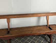 Load image into Gallery viewer, A beautiful Victorian period, pitch pine long, wide and comfortable railway bench, dating from the 2nd half of the 19th century with stunning patina. The bench features an ingenious swing-back design, so it can be sat on from both sides.
