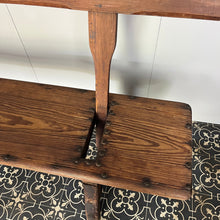 Load image into Gallery viewer, A beautiful Victorian period, pitch pine long, wide and comfortable railway bench, dating from the 2nd half of the 19th century with stunning patina. The bench features an ingenious swing-back design, so it can be sat on from both sides.
