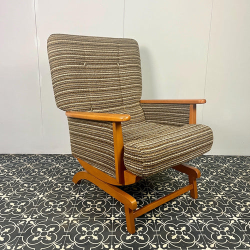 Vintage attractive Scandinavian style rocking lounge chair. The frame shows beautiful lines with arms that point straight forward and direct and create both sweeping and elegant detail.